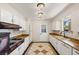 Kitchen with white cabinets, wood countertops and tile floor at 1200 Cashman Dr, Las Vegas, NV 89102