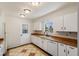 Kitchen with white cabinets, wood countertops and tile floor at 1200 Cashman Dr, Las Vegas, NV 89102