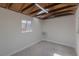 Bright studio with exposed beams, window, and air conditioner at 1200 Cashman Dr, Las Vegas, NV 89102