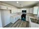 Well-lit kitchen featuring white cabinets, countertops, and updated appliances at 1881 Big Horn St, Pahrump, NV 89048