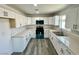 Bright, spacious kitchen with white cabinetry, countertops, and stainless-steel appliances at 1881 Big Horn St, Pahrump, NV 89048