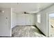 Bright living room featuring modern floors, ceiling fan, and glass sliding doors at 1881 Big Horn St, Pahrump, NV 89048
