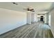 Spacious living area with modern flooring, fan, and an open concept to the kitchen at 1881 Big Horn St, Pahrump, NV 89048