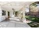 Covered patio with ceiling fans, decorative columns and overlooking landscaped yard at 2031 Mondo Ct, Las Vegas, NV 89123