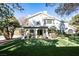 Expansive backyard featuring lush lawn, covered patio, and swimming pool, perfect for outdoor relaxation and entertainment at 2031 Mondo Ct, Las Vegas, NV 89123