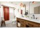 Charming bathroom with double vanity, patterned floor tiles, and decorative lighting at 2031 Mondo Ct, Las Vegas, NV 89123