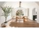 Elegant dining room features a large arched window, modern chandelier, and seating for six at 2031 Mondo Ct, Las Vegas, NV 89123