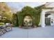 Inviting front exterior with arched window covered with vines, and sitting area at 2031 Mondo Ct, Las Vegas, NV 89123