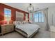 Cozy bedroom with terracotta accent wall and large windows at 2518 Veronella St, Henderson, NV 89044