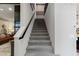 Modern staircase with gray carpet and dark wood railing at 2518 Veronella St, Henderson, NV 89044