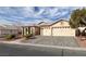 Single-story house with a three-car garage, landscaping, and a paved driveway at 2624 Torch Ave, North Las Vegas, NV 89081