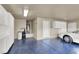 Spacious garage with painted floor, utility sink and white storage cabinets at 2624 Torch Ave, North Las Vegas, NV 89081