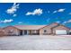 One-story home with gravel driveway, attached garage, and desert landscaping at 301 E Chevron St, Pahrump, NV 89048