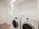 Laundry room with washer and dryer and additional shelving at 3263 Gold Run St, North Las Vegas, NV 89032