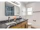 Modern bathroom with double vanity, marble countertop, and blue tile shower at 3517 Spencer St, Las Vegas, NV 89169