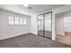 Bedroom with mirrored closet doors and grey carpet at 3517 Spencer St, Las Vegas, NV 89169