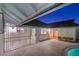 Night view of the pool and patio area with metal gate at 3517 Spencer St, Las Vegas, NV 89169