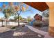 Charming backyard featuring a playhouse, pool, mature trees, and a stone walkway at 368 E Rush Ave, Las Vegas, NV 89183