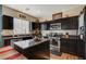 Modern kitchen with dark cabinetry, granite counters, and stainless steel appliances at 4137 Keasberry Ave, North Las Vegas, NV 89081