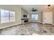 Living room featuring a fireplace, tile floors, and large windows at 4307 Pageantry Falls Dr, North Las Vegas, NV 89031