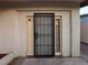 Side entrance with security gate and small window at 4911 Lana Dr, Las Vegas, NV 89121