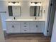 Double vanity bathroom with modern fixtures and white cabinets at 4918 Schumann Dr, Las Vegas, NV 89146