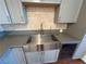 Modern farmhouse sink and wine cooler in updated kitchen at 5337 Hacienda Cir, Las Vegas, NV 89120