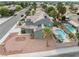 Aerial view of home with solar panels, sparkling pool, outdoor kitchen, and desert landscaping at 6112 Browning Way, Las Vegas, NV 89130