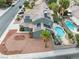 Aerial view of the property showcasing the house, backyard pool, outdoor kitchen, desert landscaping, and solar panels at 6112 Browning Way, Las Vegas, NV 89130