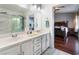 Bathroom with double sinks, marble shower, and a view of the bedroom at 6112 Browning Way, Las Vegas, NV 89130