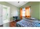 Bedroom with wood floors, en-suite bathroom, and workspace at 6112 Browning Way, Las Vegas, NV 89130