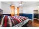 Bedroom with hardwood floors, ceiling fan and colorful striped bedding at 6112 Browning Way, Las Vegas, NV 89130