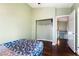 Bedroom with wood floors, closet, and access to upper level at 6112 Browning Way, Las Vegas, NV 89130