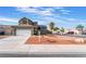Attractive home with a spacious driveway and desert landscaping, offering a welcoming first impression at 6112 Browning Way, Las Vegas, NV 89130