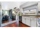 Open kitchen with stainless steel appliances and breakfast bar at 6112 Browning Way, Las Vegas, NV 89130