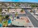 Scenic aerial neighborhood view featuring a home with solar panels, a pool, and lush landscaping in a vibrant community at 6112 Browning Way, Las Vegas, NV 89130