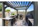 Outdoor kitchen with tiled floors, seating, granite counters, and built-in BBQ grill, ideal for entertaining at 6112 Browning Way, Las Vegas, NV 89130