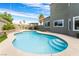 Beautiful pool with baja step, concrete surround, and outdoor kitchen for relaxing and entertaining at 6112 Browning Way, Las Vegas, NV 89130