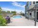 Inviting kidney-shaped pool with a spacious patio and pergola at 6112 Browning Way, Las Vegas, NV 89130
