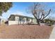 Single story home with a spacious front yard and mature tree at 6214 Gunderson Blvd, Las Vegas, NV 89103