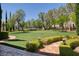 Expansive lawn with manicured hedges, stone pathway, and outdoor lighting at 66 Innisbrook Ave, Las Vegas, NV 89113