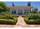Landscaped backyard with stone pathway, rose bushes, and elegant outdoor space at 66 Innisbrook Ave, Las Vegas, NV 89113