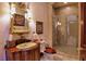 Charming bathroom with ornate mirror, decorative sink, and mosaic tile shower at 66 Innisbrook Ave, Las Vegas, NV 89113