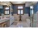 Clean bathroom with white tile, double vanity, and a large bathtub at 66 Innisbrook Ave, Las Vegas, NV 89113