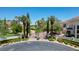 Grand estate entrance with gated community, lush landscaping, and palm trees at 66 Innisbrook Ave, Las Vegas, NV 89113