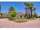 Luxury home with palm trees, brick driveway, and manicured landscaping at 66 Innisbrook Ave, Las Vegas, NV 89113
