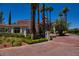 Luxury home exterior with gated entrance, palm trees, and brick driveway at 66 Innisbrook Ave, Las Vegas, NV 89113