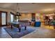 Spacious game room with pool table, comfortable seating, and views into kitchen at 66 Innisbrook Ave, Las Vegas, NV 89113