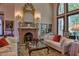 Elegant living room with ornate fireplace, high ceilings, and comfortable seating at 66 Innisbrook Ave, Las Vegas, NV 89113