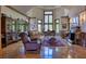 Bright living room with hardwood floors, large windows, and a fireplace at 66 Innisbrook Ave, Las Vegas, NV 89113